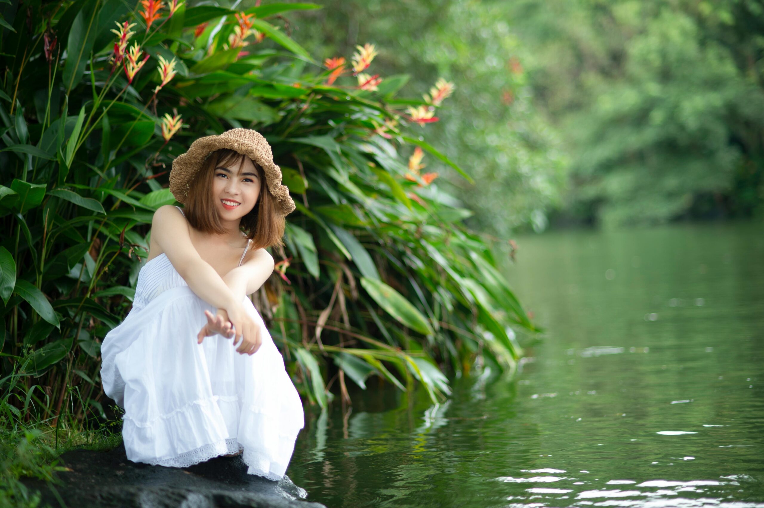 Tina sitting in a park smiling after completing her therapy journey.