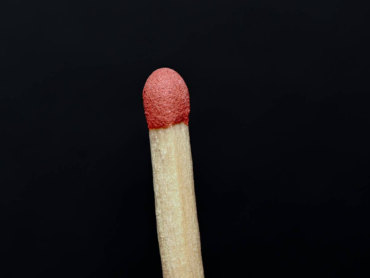 Close-up of matchstick against black background