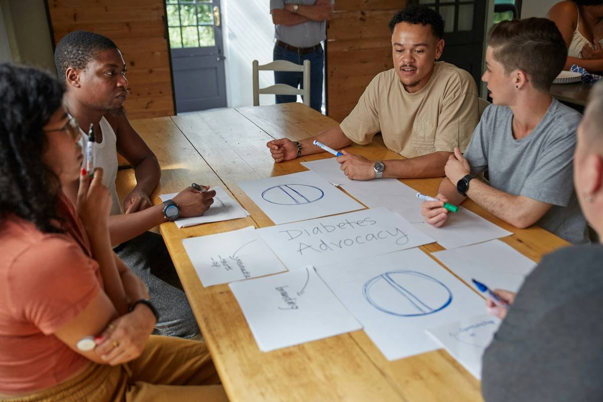People collaborate on a project at a table.