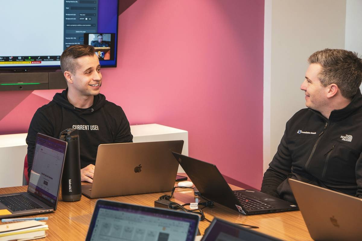 Smiling developers working together happily.