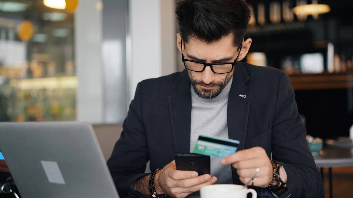 credit kidnap ransom insurance strategy showing a traveler reviewing policy documents while on a laptop near a map